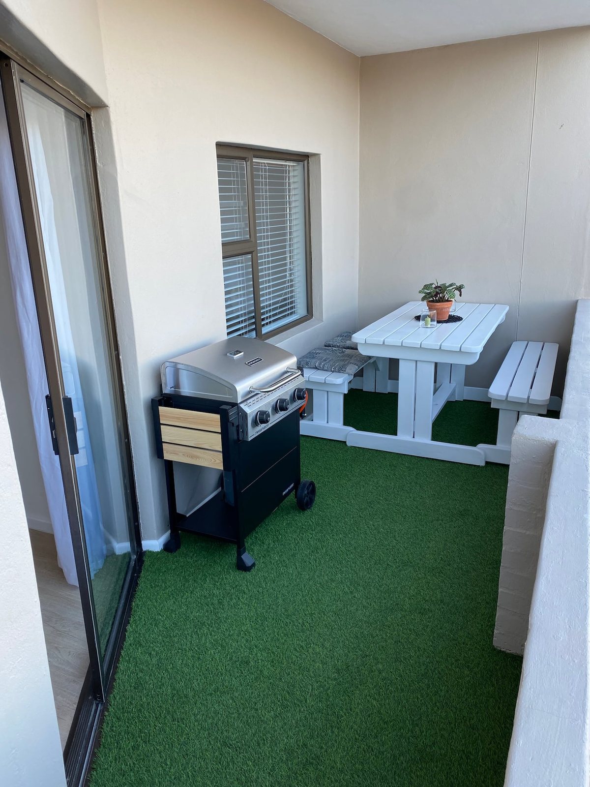 Private balcony at Atlantic Apartment with a braai and outdoor dining table