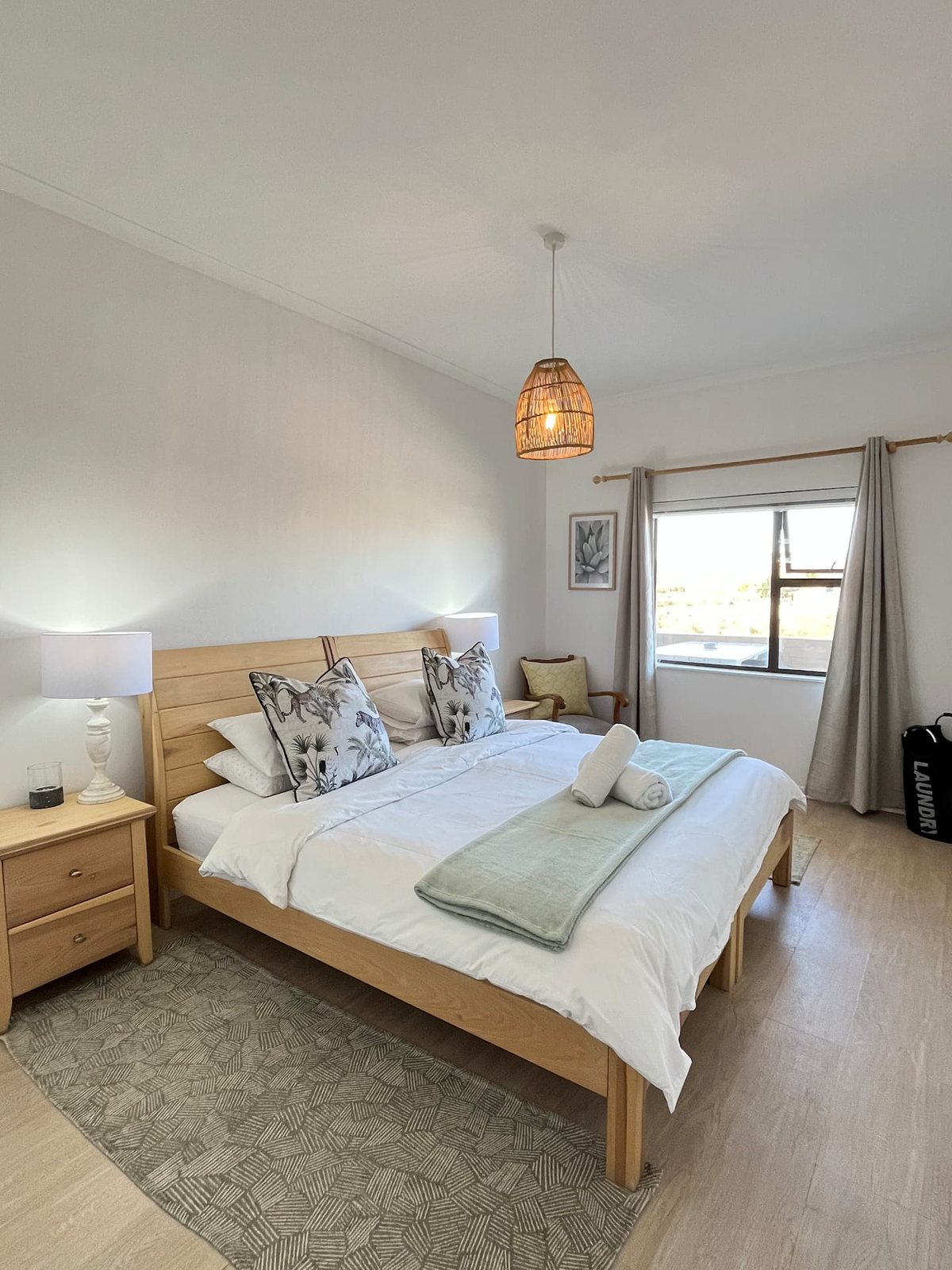 King bedroom at Atlantic Apartment with a wooden bed frame and balcony views