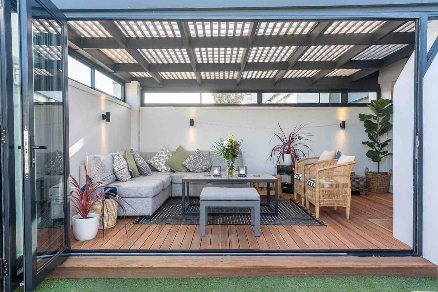 Wooden deck and lounge at Atlantic Beach Cottage opening onto the garden
