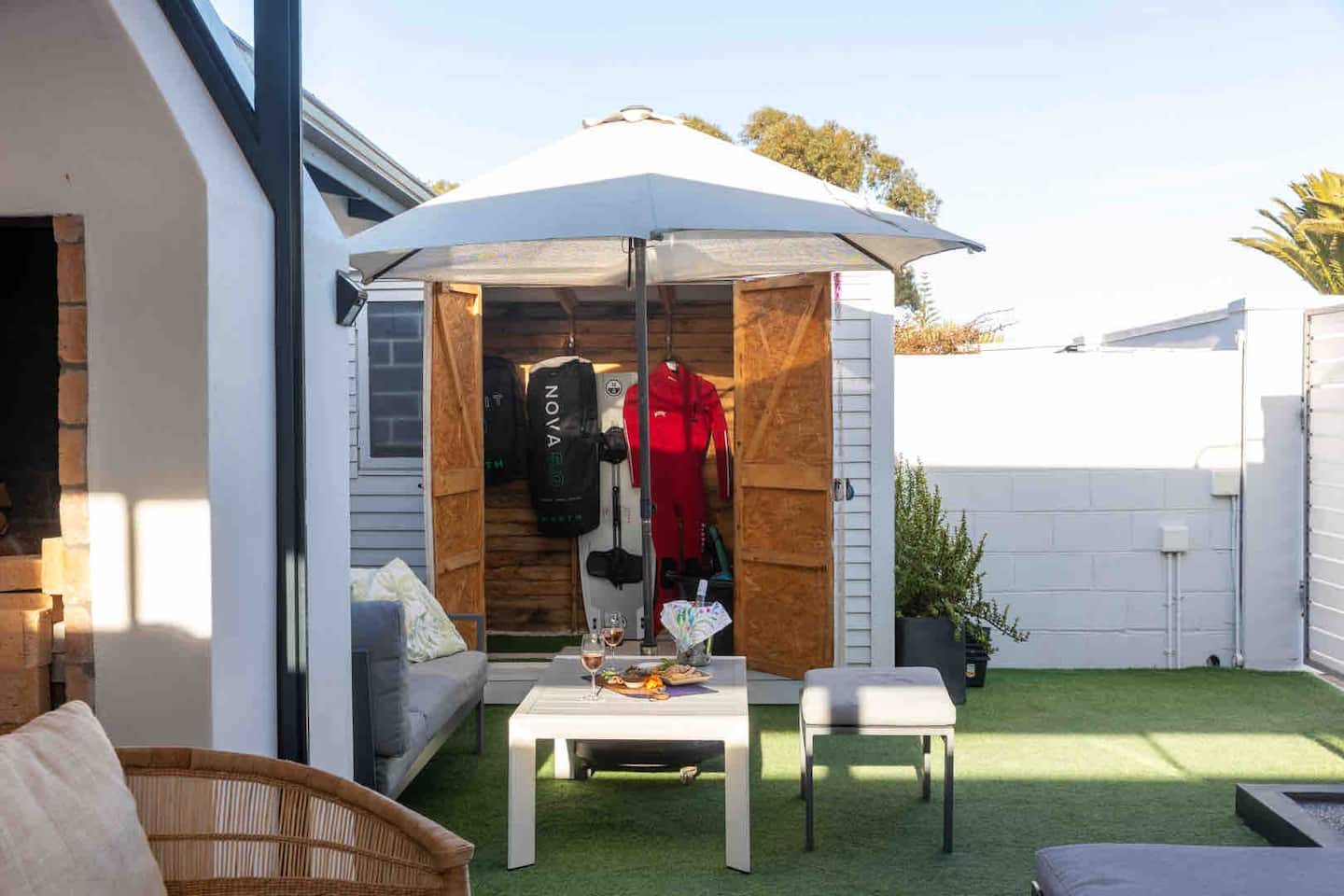 Braai patio at Atlantic Beach Cottage with a lockable kite and watersports gear store