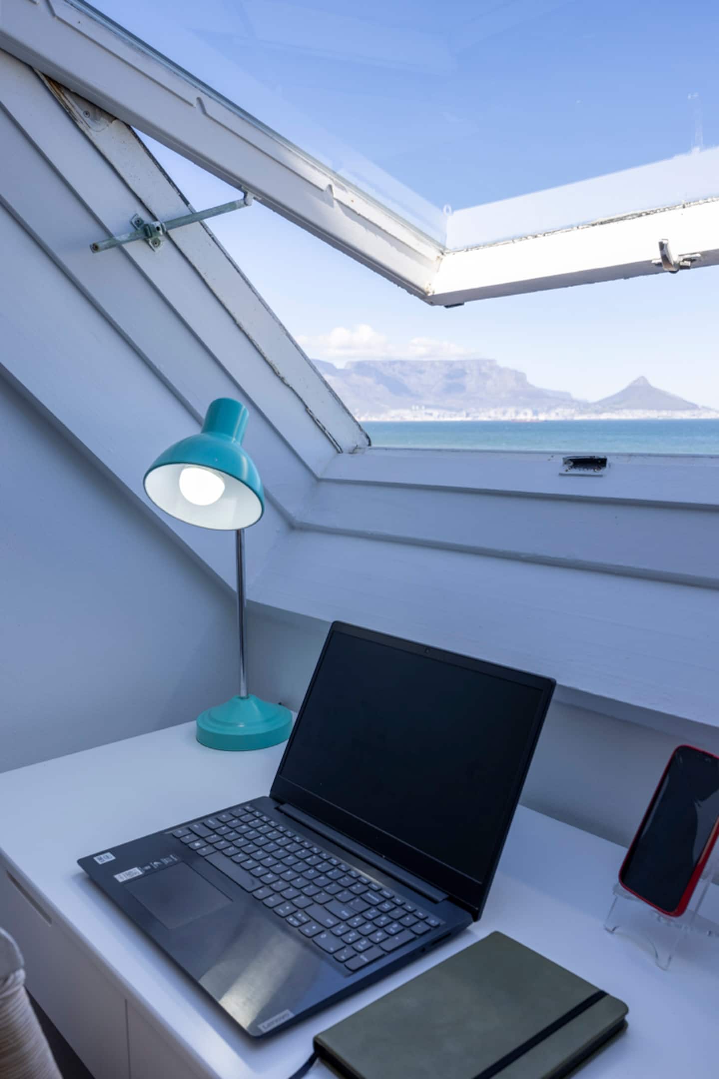 Workspace nook at Atlantic Seaview with a desk under a skylight looking out to Table Mountain