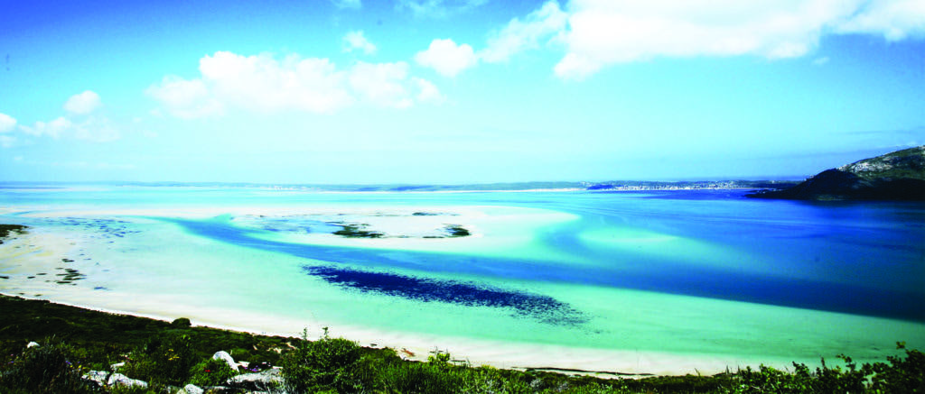 Langebaan Lagoon seen from the shore, with white sandbanks and turquoise water stretching to the horizon